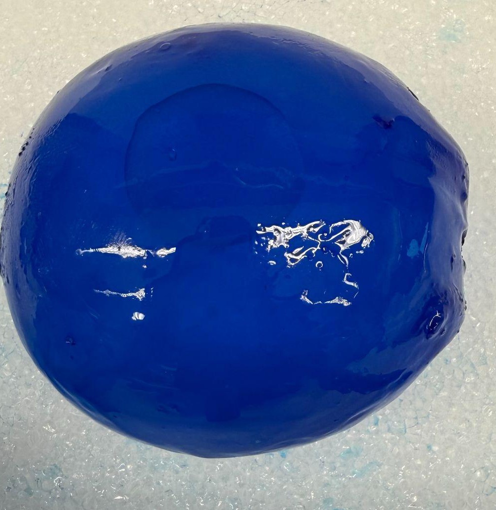 A tissue expander coated in blue hydrogel, inflated to 200 percent of its starting volume, with the blue coating covering the whole shell.